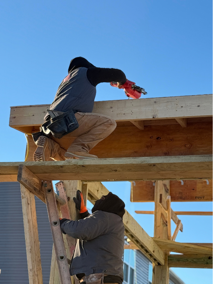 Workers framing pavilion roof structure